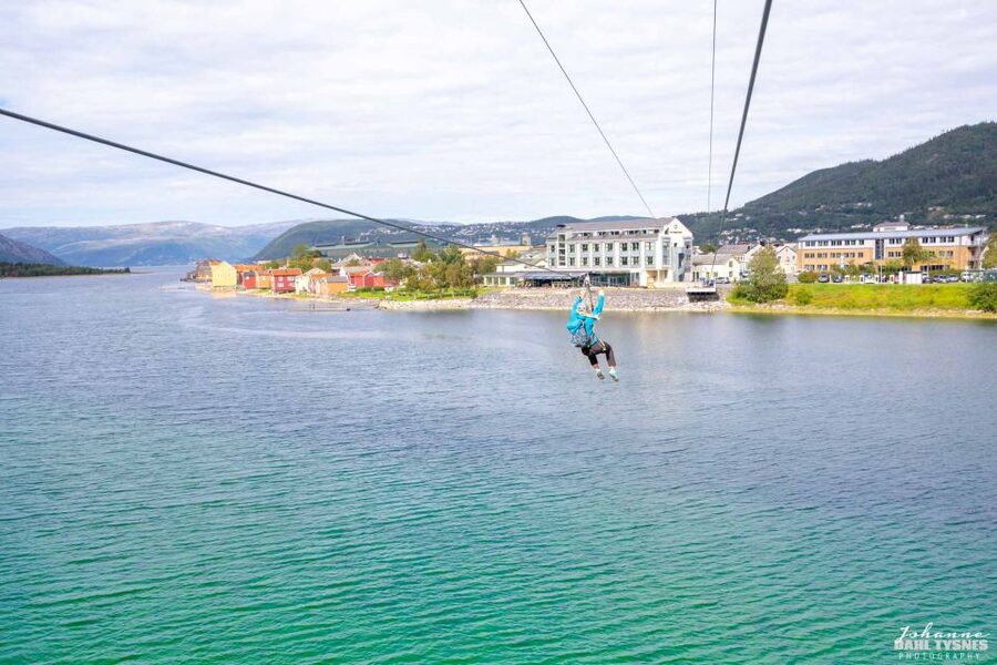 Feel the adrenaline in Mosjøen Zipline - Getting harnessed on Storfjellet, with guide help at takeoff
